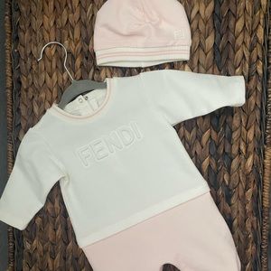 Fendi baby onesie and beanie set.